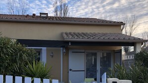 A house with a covered patio, a white picket fence, and a door with a glass panel. - COMFORTABLE VILLA NEAR EUROPARK (Vias)