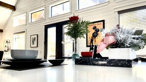 A kitchen with a marble countertop, a vase with a red rose, and a framed poster on the wall. - First Kiss Cabin | Romantic | Hot Tub | Fireplace (Broken Bow)