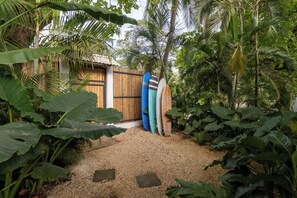 Surf-inspired garden with lush tropical plants and a serene atmosphere.