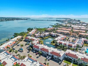 A coastal hotel with multiple buildings, a marina, and a pier.