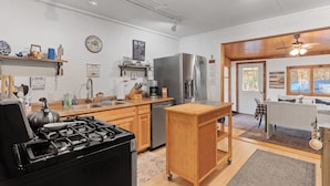 A modern kitchen with a gas stove, stainless steel appliances, wooden cabinets, and a central island. - Big Indian near
 Full Moon Resort Spillian Onteora Mountain House Ski Belleayre  (Big Indian)