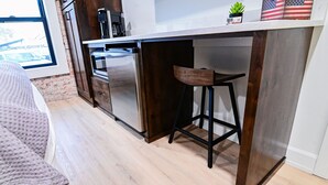 A kitchen with a wooden countertop, a stainless steel refrigerator, and a bar stool. - Mountain Home Theme: Suites of Lava #4 (Lava Hot Springs)
