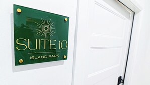 A sign for 'SUITE 10' at 'ISLAND PARK' with a sunburst logo.