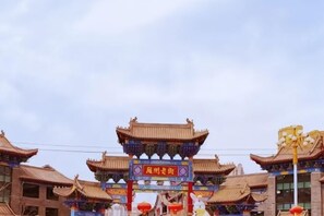 A traditional Chinese gate with ornate architecture and a signboard.