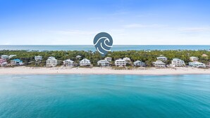 A coastal property with multiple beachfront villas, a sandy beach, and a clear view of the ocean. - Sounds of Summer: Beachfront, Sun Deck, Screened Porch (St. George Island)