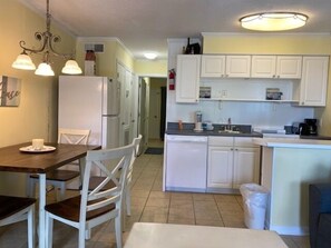 Enjoy cooking in this well-equipped kitchen with a central island, dining table, and modern appliances.