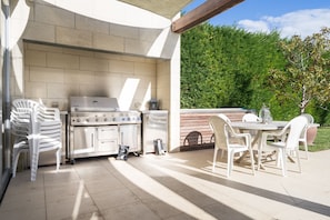 Enjoy al fresco dining on the patio with a barbecue grill and dining table for four.