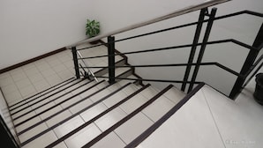 A staircase with black handrails and white steps. - Check Inn Pension Arcade (Dumaguete)