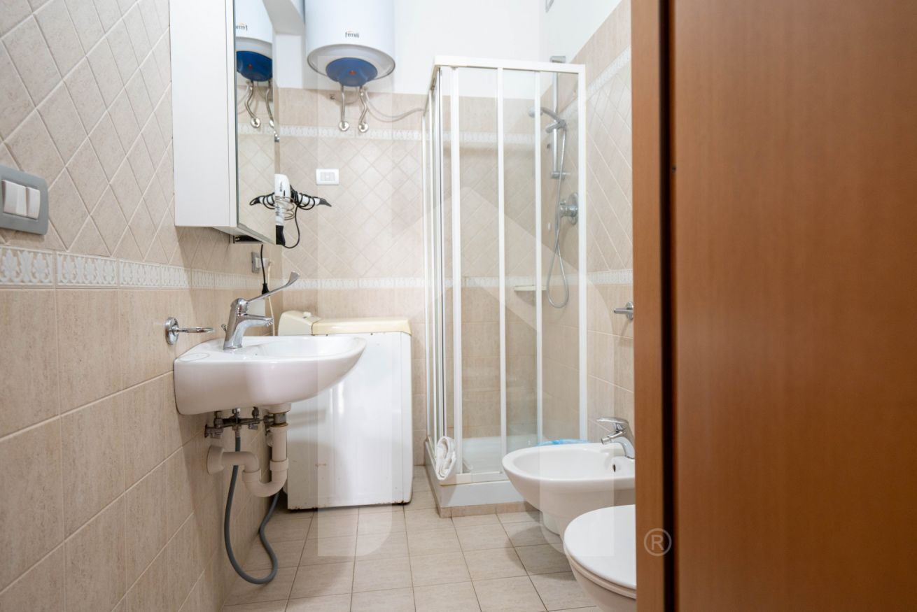 A bathroom with a sink, toilet, and shower.