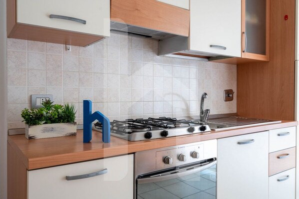 A modern kitchen with a gas stove, oven, and a built-in sink.