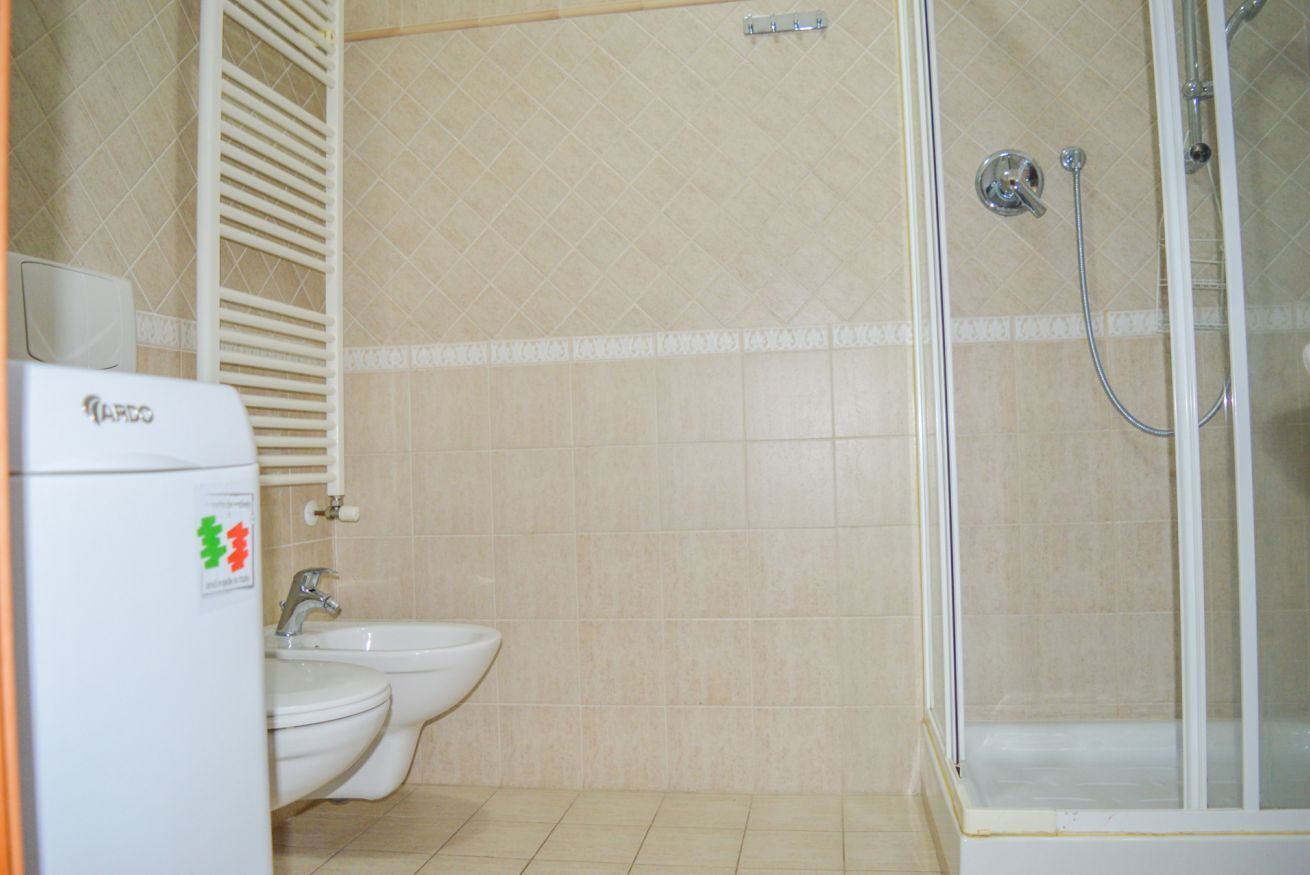 Ein Badezimmer mit Toilette, Bidet und einer Duschkabine.
