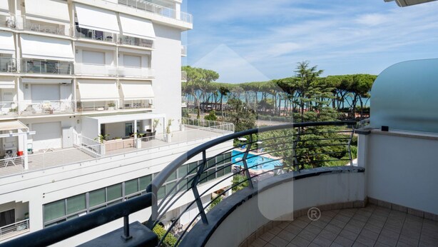 A multi-story building with balconies, a pool, and a view of trees and water. - Holiday Rendez Vous 25 - First floor apartment with side sea view (Pineto)