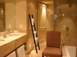 A bathroom with a large mirror, a sink, and a shower area. - Royal Palm Hotel Umhlanga (Umhlanga)