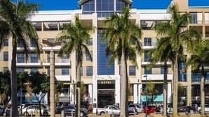 A hotel with a curved facade, multiple floors, and a prominent entrance.