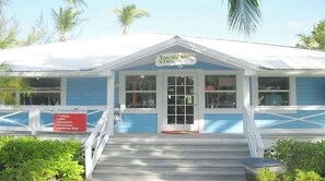 Step up to the entrance of this charming establishment, where a signboard lists the services and products available.