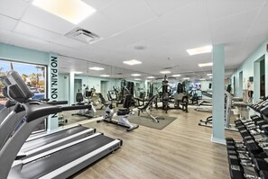 A gym with treadmills, weight machines, and free weights.