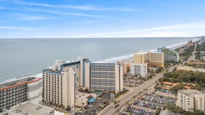 A coastal cityscape with high-rise hotels, a beach, and a clear sky. - Double balcony ocean view condo at Ocean reef resort (Myrtle Beach)