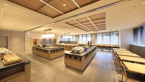 A modern kitchen with wooden cabinets, a central island, and bar stools. - JR WEST GROUP VIA INN PRIME AKASAKA (Tokyo)