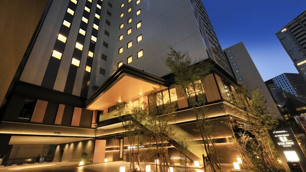 A modern hotel with multiple floors, outdoor lighting, and a staircase connecting levels. - JR WEST GROUP VIA INN PRIME AKASAKA (Tokyo)