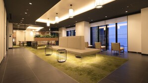 A modern lobby with a seating area, a reception desk, and large windows. - JR WEST GROUP VIA INN PRIME AKASAKA (Tokyo)