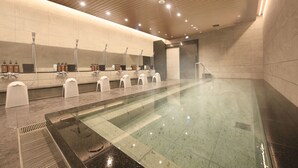 A modern indoor swimming pool with multiple showerheads and a clear glass bottom. - JR WEST GROUP VIA INN PRIME AKASAKA (Tokyo)