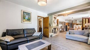 Amplia sala de estar con chimenea, dos sofás y una mesa de centro.