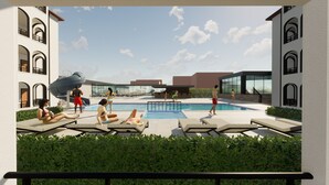 A modern outdoor pool area with lounge chairs, a water slide, and a glass-enclosed building in the background. - Akalia Resort Hotel (Manavgat)