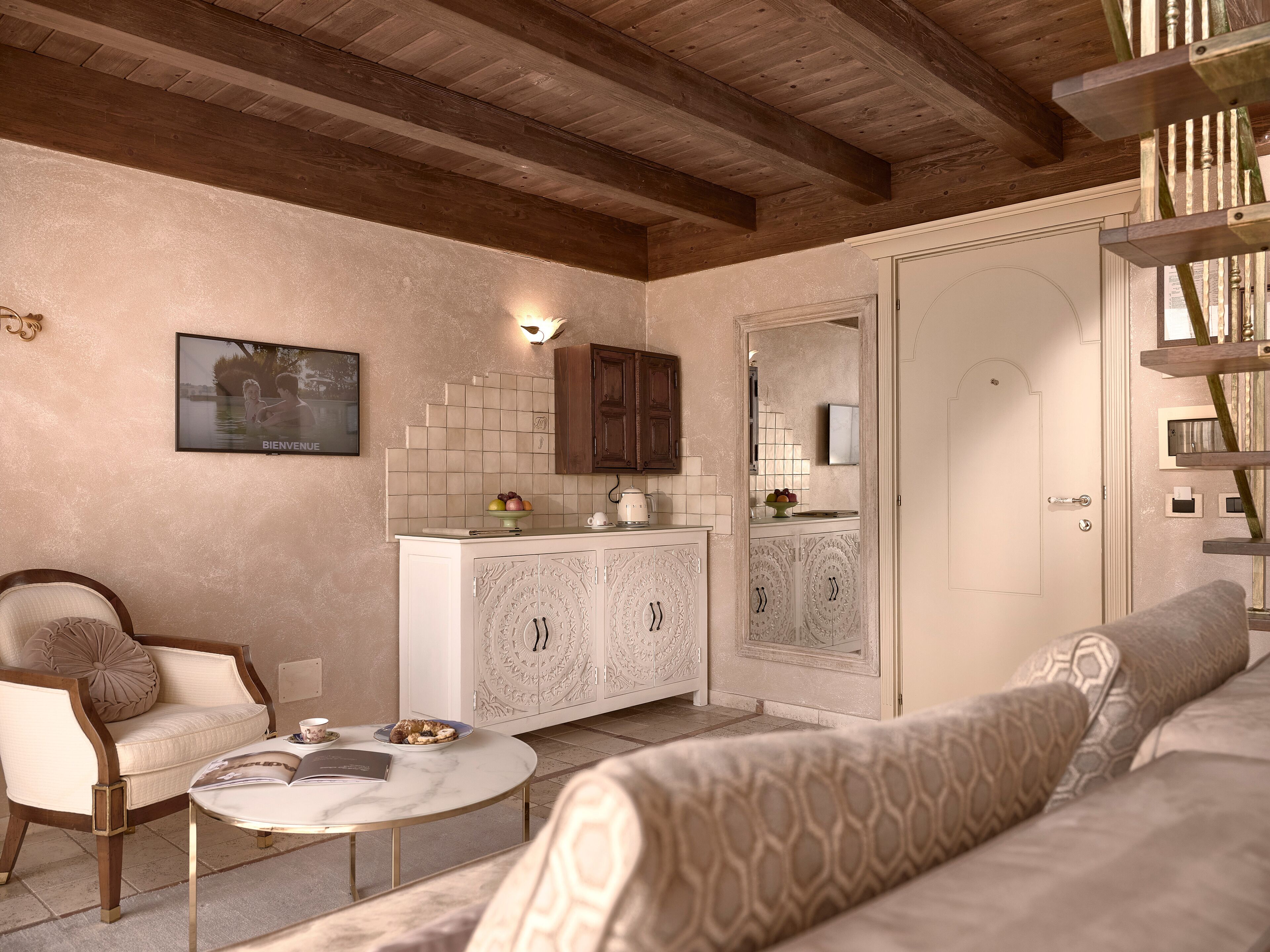 A living room with a sofa, a coffee table, a chair, and a cabinet.