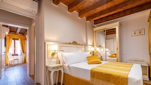 A hotel room with a bed, bedside tables, a mirror, and a window with curtains. - Apartment (Venezia)