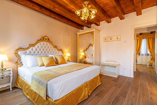 A bedroom with a large bed, a mirror, a nightstand, and a wooden ceiling.