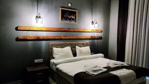 A modern bedroom with a large bed, wooden headboard, and a nightstand. - Agva Green Blue Otel (Sile)
