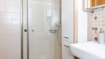 Shower, hair dryer, soap, toilet paper