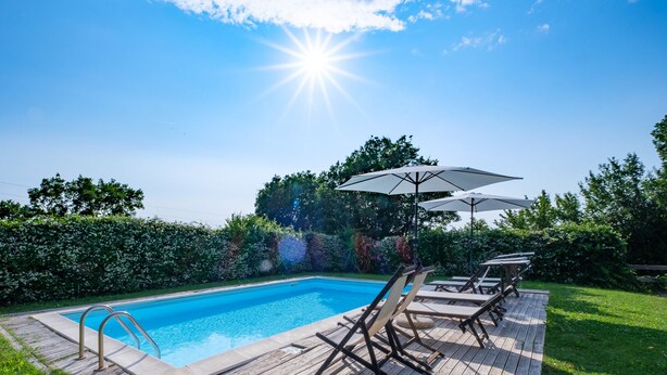 A swimming pool with wooden deck and lounge chairs, surrounded by greenery. - APARTMENT 6 PEOPLE IN COUNTRY VILLA WITH POOL (Lame)