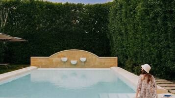 Seasonal outdoor pool, open 9:00 AM to 6:00 PM, pool umbrellas