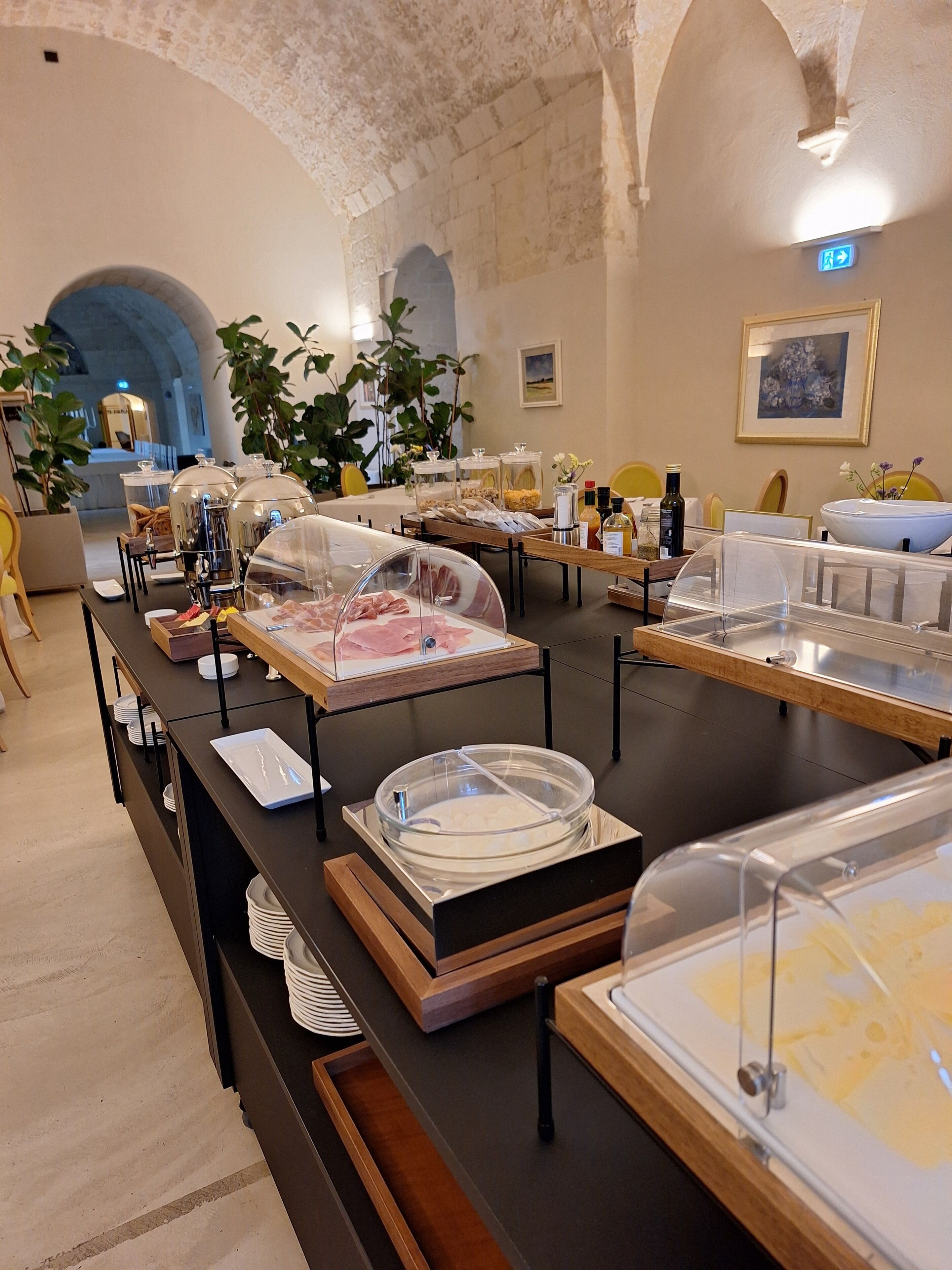 A buffet setup with various food items and a clear glass display case.