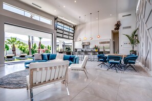 Relax in a spacious open-plan living space with a seating area, dining table, and kitchen.