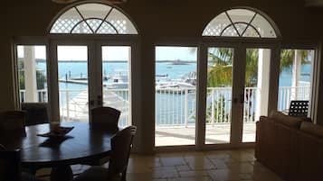 A dining area with a view of the marina and ocean.