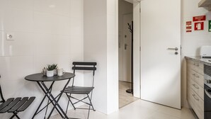 A modern kitchen with white cabinets, a built-in oven, and a countertop. - Apartment (Lisboa)