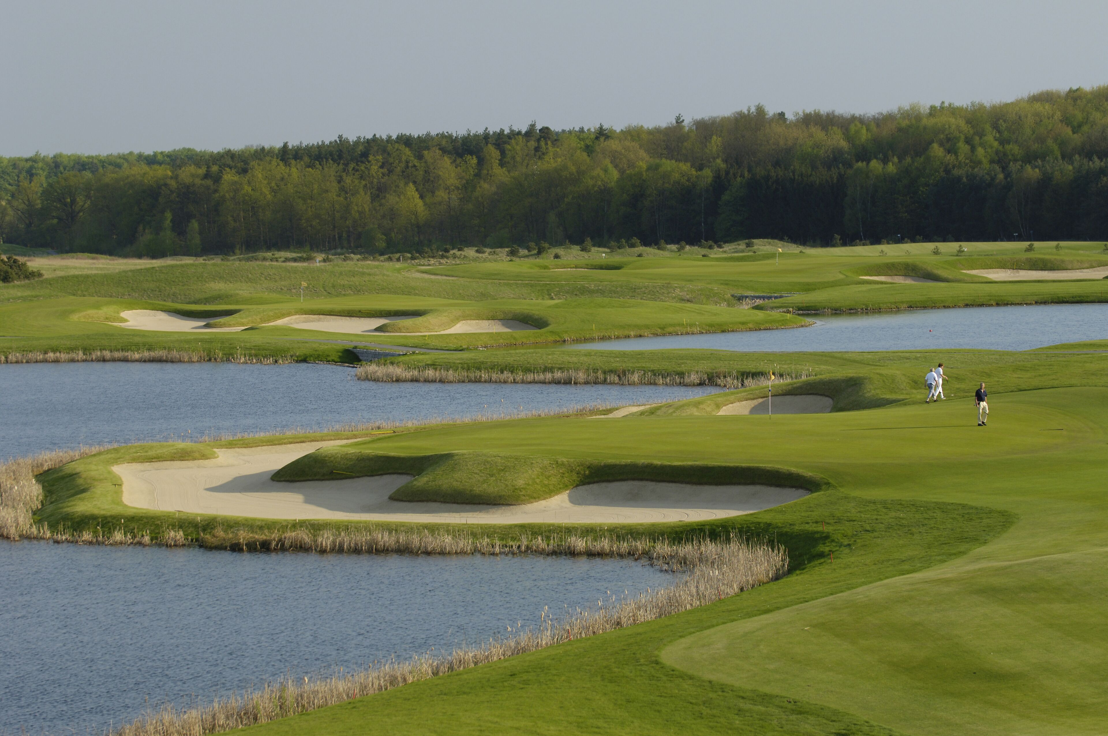 A golf course with sand bunkers and water hazards.