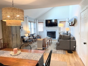 Smart TV, fireplace, books, computer monitors