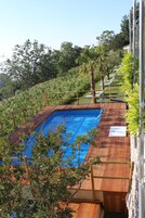 Una piscina al aire libre de temporada, sombrillas