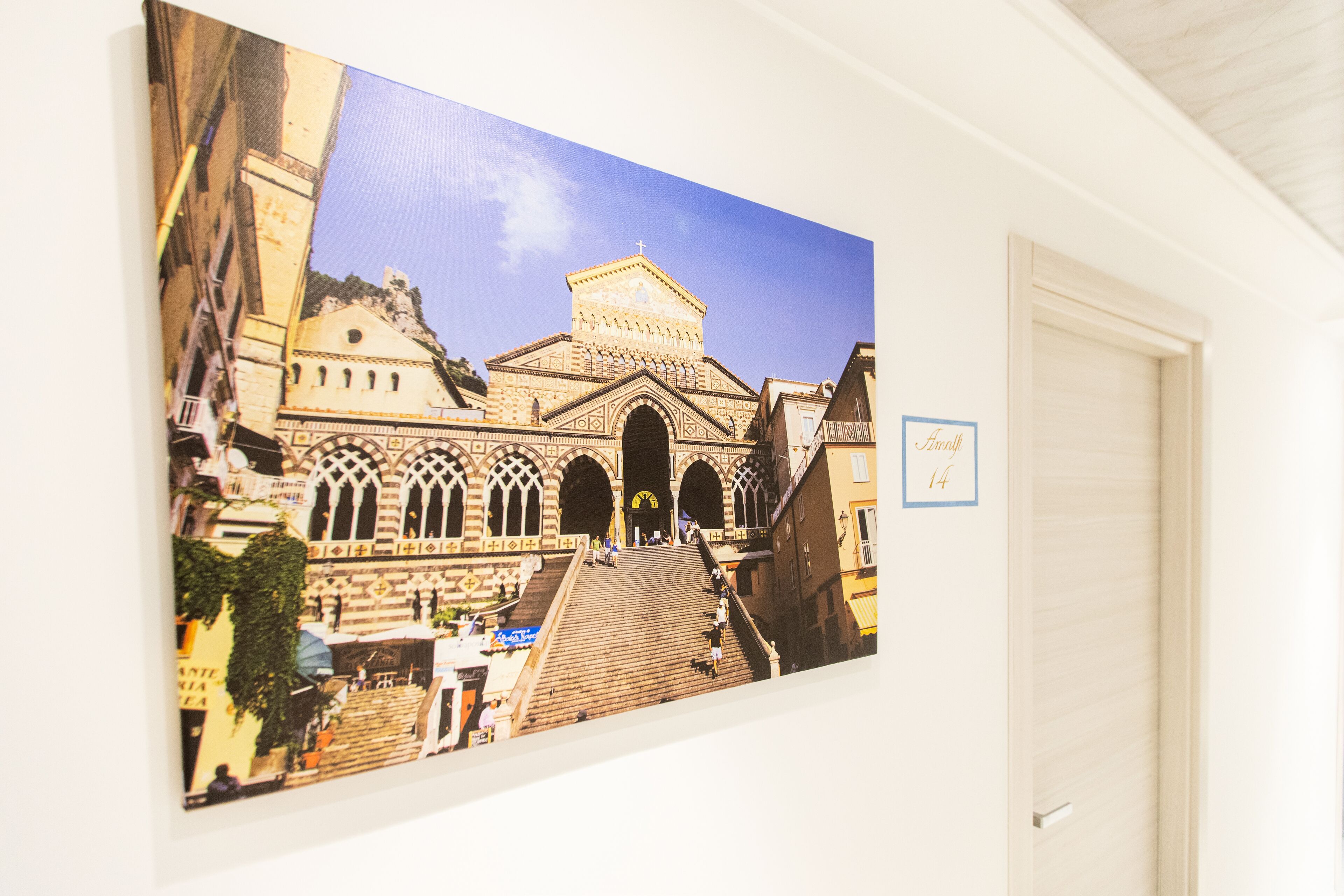 A large framed photograph of a historic building with a prominent entrance and steps leading up to it.