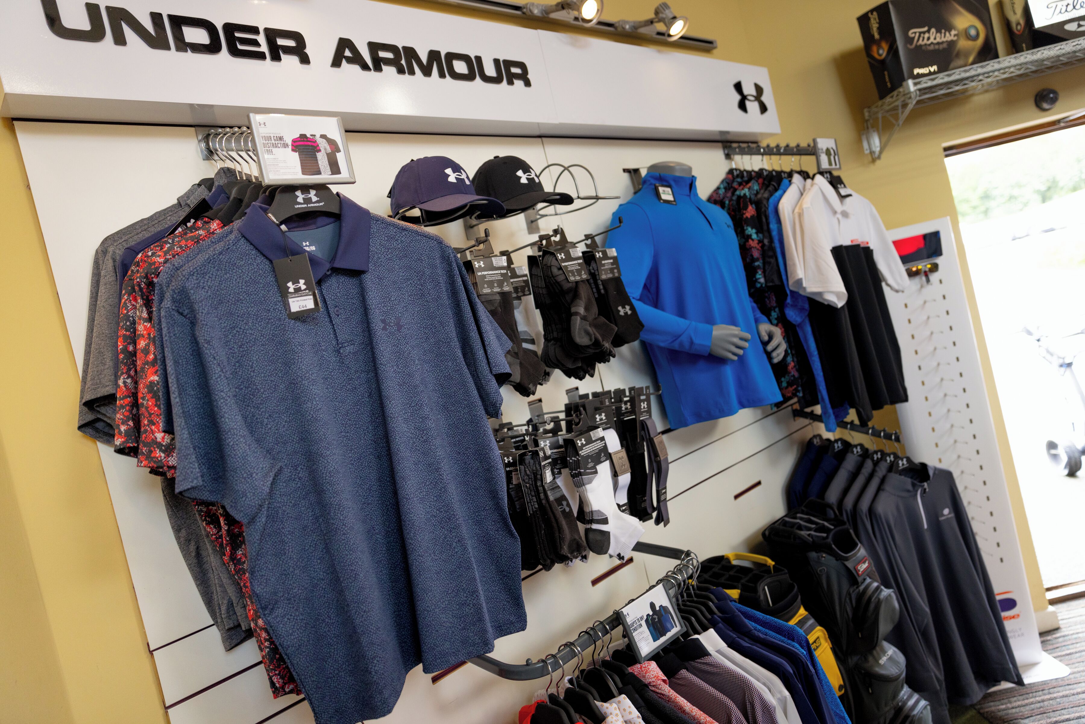 A clothing store with various apparel items on display, including shirts, pants, and accessories.