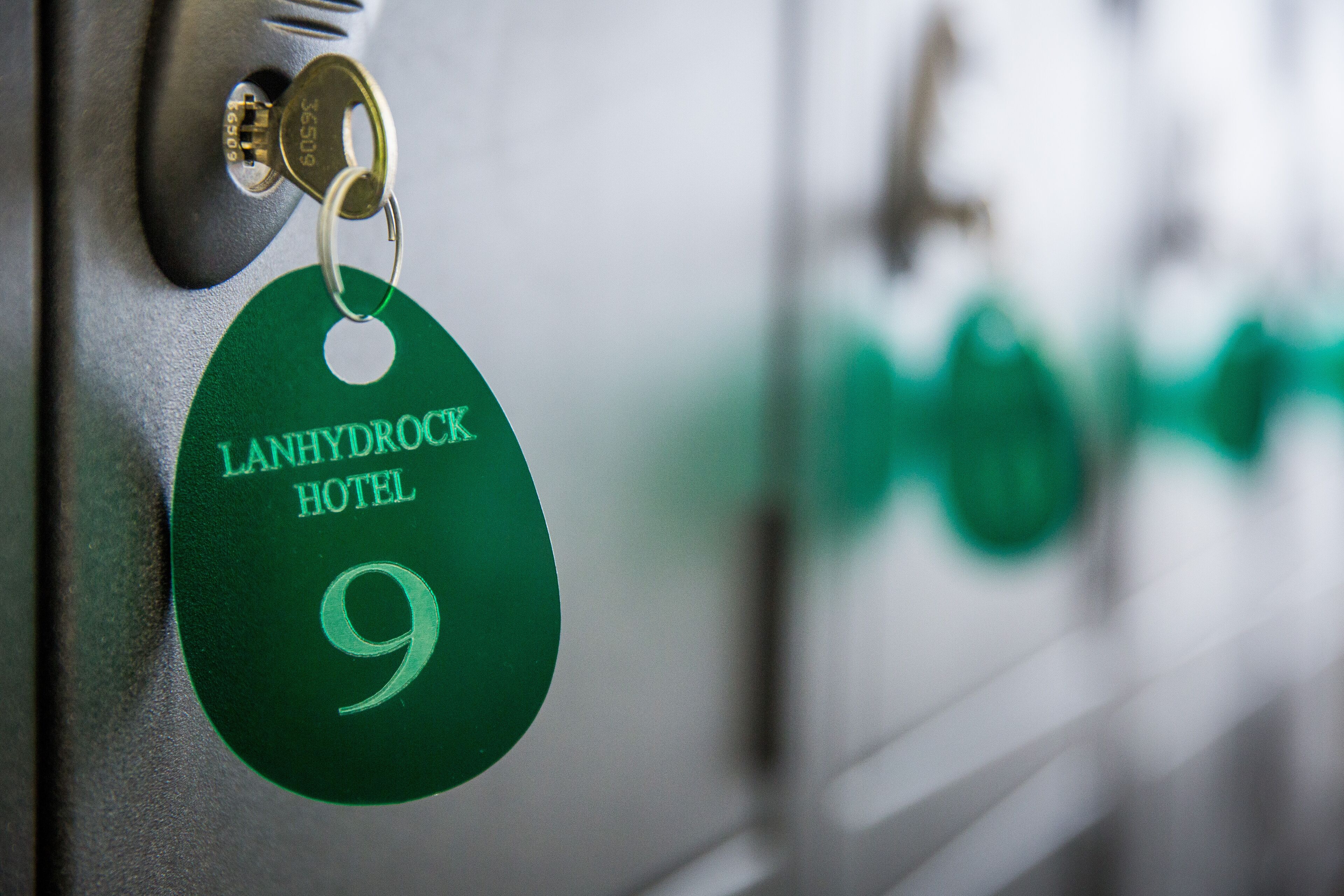 A key with a hotel tag labeled "LANHYDROCK HOTEL 9".