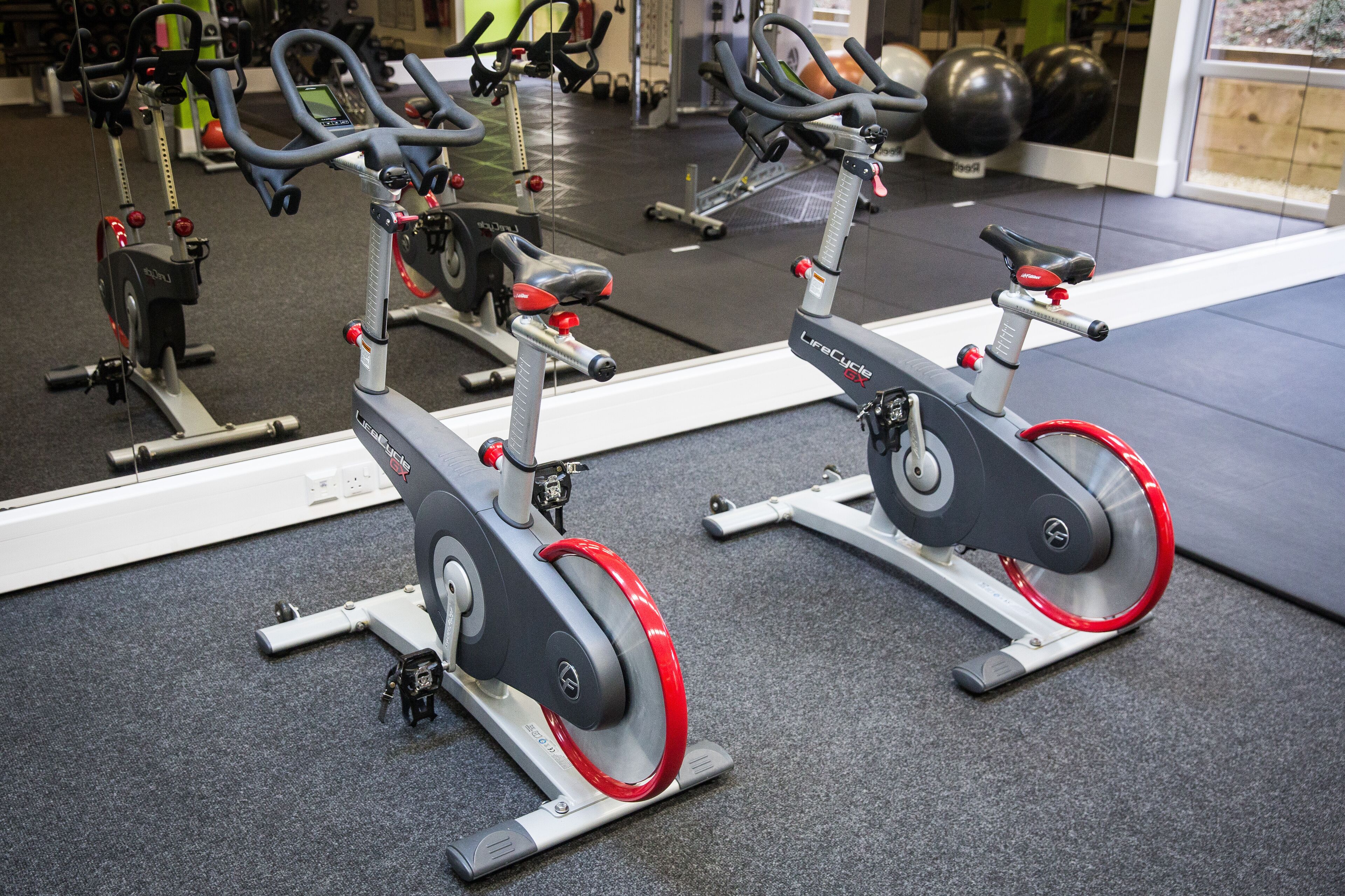 A gym with stationary bikes and exercise equipment.