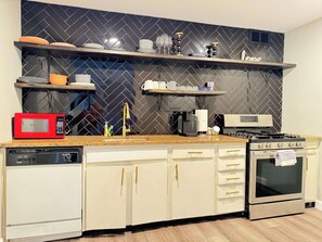 Enjoy cooking in this well-equipped kitchen with a granite countertop, stainless steel appliances, and ample storage.