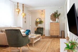 A modern living room with a sofa, chairs, a coffee table, and a TV. - Genteel Home Mercado Central Terrace (Cadiz)
