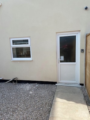 A house with a white door and a window.