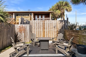 Comfortable seating circles the fire pit, creating a perfect spot for evening gatherings. - Dog-Friendly, Steps to Beach & Gulf Sunsets | Beach Bungalow (Panama City Beach)