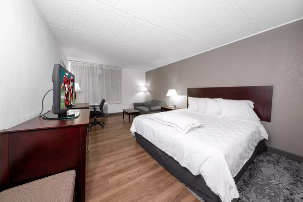 Unwind in a spacious king room with cozy seating.